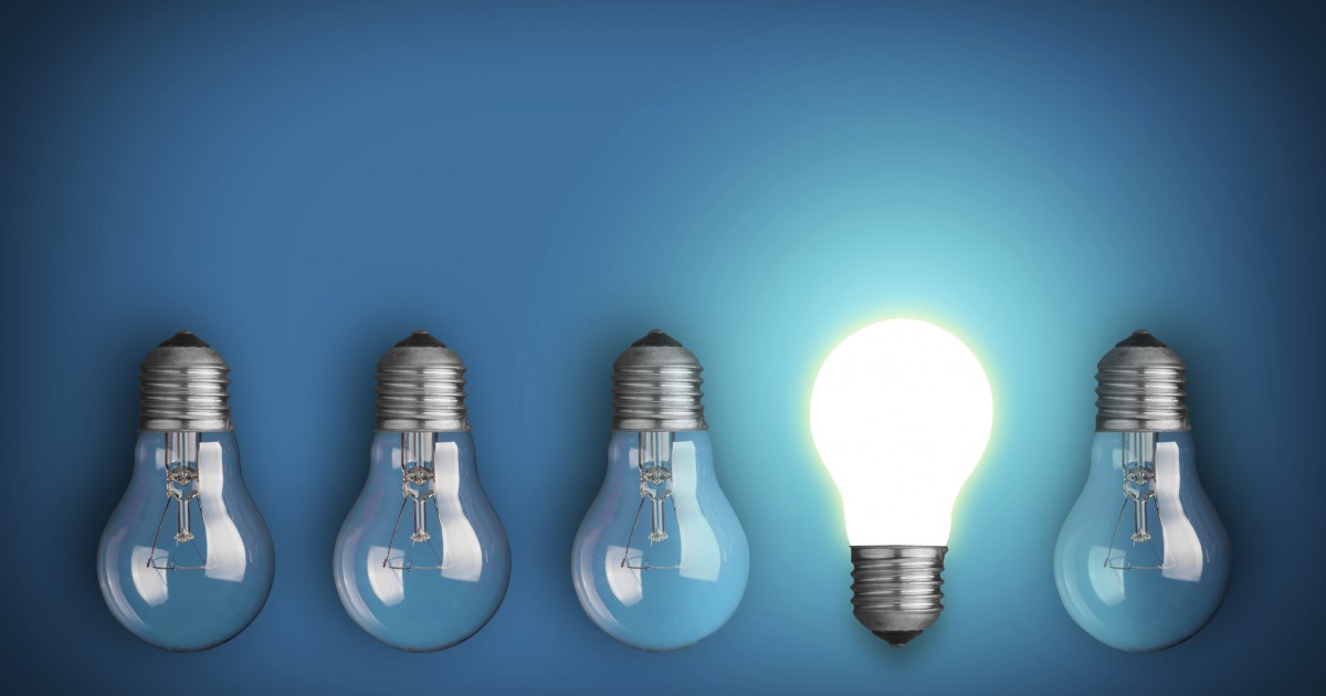 Idea concept with row of light bulbs and glowing bulb